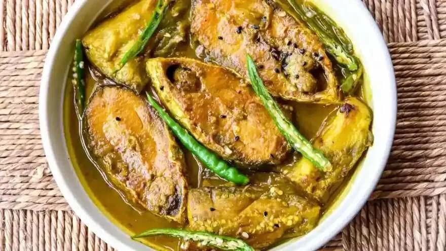 Hilsa steaks in a golden mustard and green chilli curry