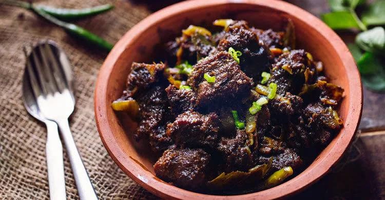 Dark Chattogram-style mezban beef in an earthen bowl