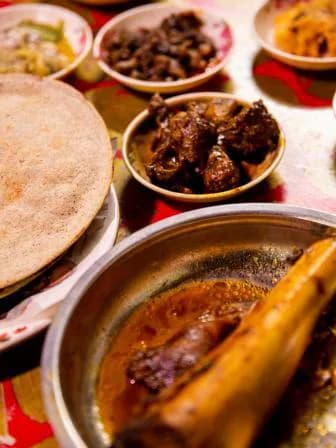 Kalai ruti beside a bowl of beef bhuna